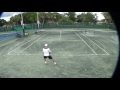 Tennis roman borvanov plays a point against a junior on clay