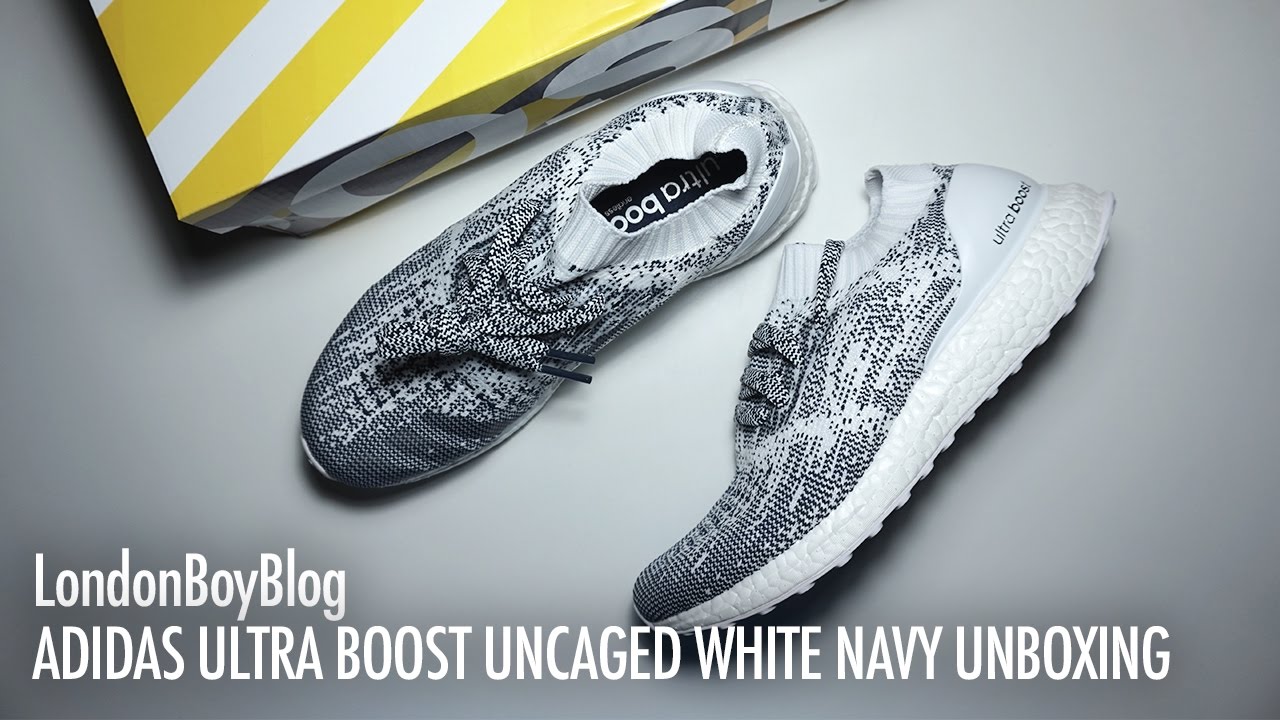 ultra boost uncaged white navy on feet