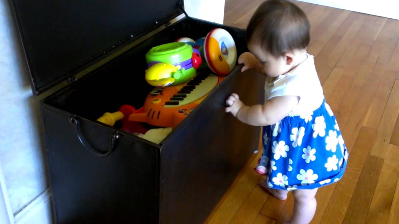 Elle and standing at the toy trunk