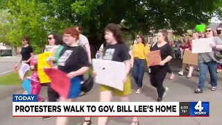 Protesters walk to Gov. Lee's home