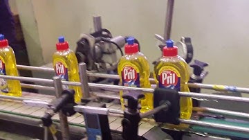 Automatic Filling, Capping and Labelling Machine. Full Bottled Production Process