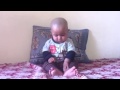 Baby six month old eating biscuit