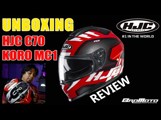 carrying motorcycle helmet man carrying a motorcycle helmet in his hands Stock Photo