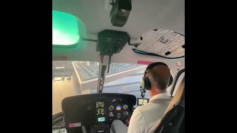 A helicopter is hovering around a multi-storey building in New York .
