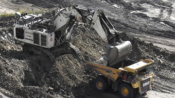 Top View of Liebherr R 9350 Excavator Load Overburden into Komatsu HD785 & CAT 777D Dump Trucks