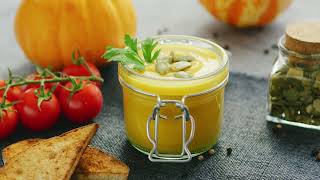 creamy pumpkin soup in jar with bread and tomatoes | Free Stock Video without Watermark or Copyright