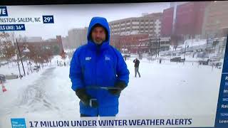 Alex in background of Weather Channel broadcast
