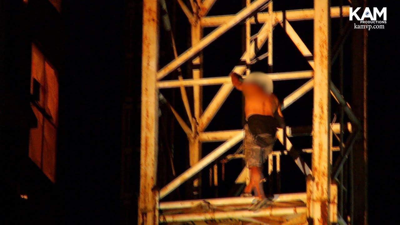 Man Climbs a large Crane and refuses to come down - YouTube