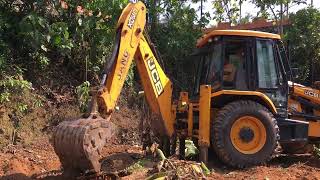 jcb 3dx cleaning land by removing remnants of banana trees for next cultivation