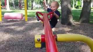 Toddler falls off teeter totter.