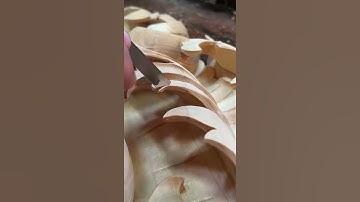 the process of carving wood manually into the desired shape