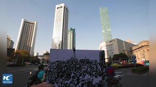 Elderly Chinese couple take photos to commemorate Nanjing Massacre