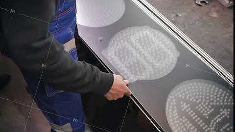 Repair and assembly of LED traffic lights at the factory close-up. A worker installs an anti