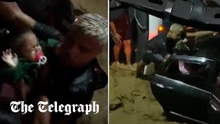 video: Watch: Baby rescued from car moments before being washed away in Brazilian storm