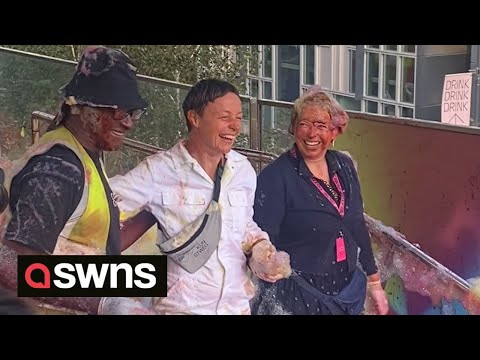 Hilarious moment art installation goes wrong drenching worker in rainbow-coloured foam | SWNS