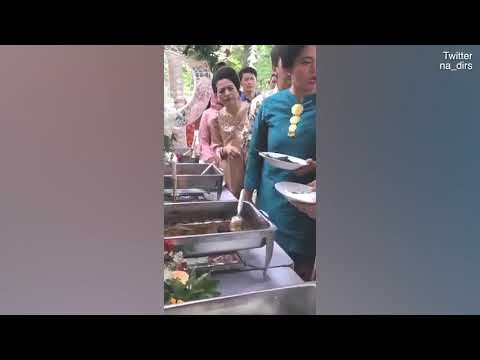 Video: Two immaculately dressed Indonesian wedding guests argue over curry