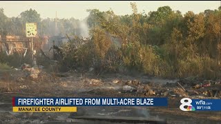 Firefighter airlifted from multi-acre Manatee County fire