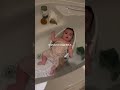Look how the baby is having fun while taking a bath.