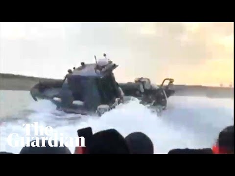 Footage shows French police causing waves to flood migrant dinghy