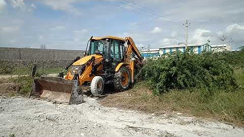 new jcb 3dx machine removing unwanted trees and clearing the open land