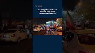 Iranians gather and wave national flags after ceasefire announced