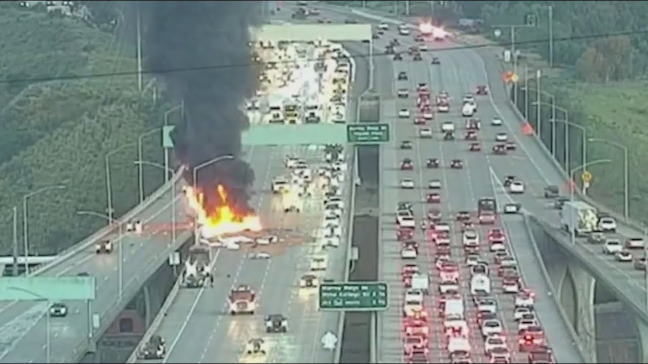 Semi truck crashes, bursts into flames on I-805