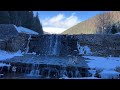 Calming powerful mountain waterfall în winter , real and natural . Relaxing sounds of nature .