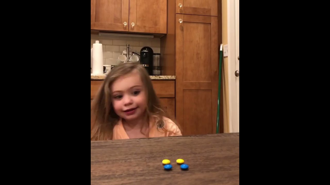 Toddler Sneaks Out Candy From Bag When Parent Asks Her Not To Touch Those Kept On Table 1359984