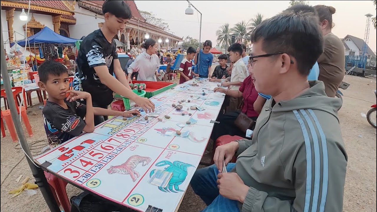 พาชมงานบุญฝั่งลาว แทงปูปลาเต้างานบุญบ้านสะผ่าย|ພາຊົມງານບຸນຝັ່ງລາວ