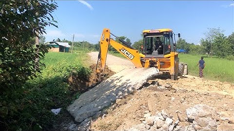 JCB Backhoe Throwing Out Heavy Concrete Slab From Road - JCB VIDEO