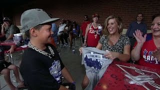 Young fan gives t-shirt to surprised girl