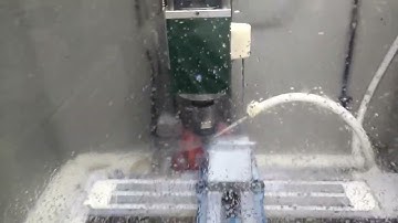 CNC mini mill cutting with flood coolant