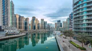 View of Dubai Marina Towers and canal in Dubai night to day timelapse