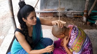 Woman headshave by lady barber with scissors