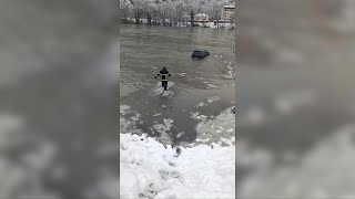 Bosnian firefighter saves car from freezing river after flooding | AFP