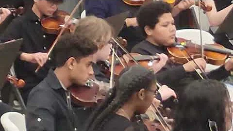 Dean and the 7th and 8th Grade orchestra performin...