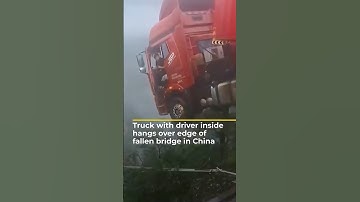 Truck with driver inside hangs over edge of fallen bridge in China | AJ #shorts