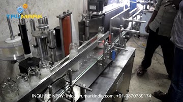 automatic labeling machine - transparent labels on glass bottle