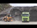 Volvo L110H loading Volvo FH trucks in a quarry