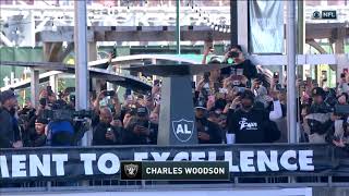 Charles Woodson lights the final torch at the Coliseum