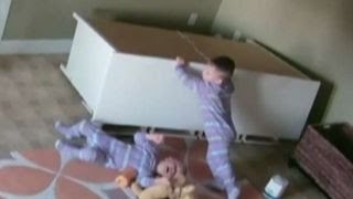 Toddler pushes dresser off twin brother stuck underneath