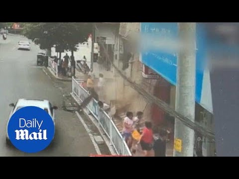 Shop signboard collapses onto pedestrians on a busy street in China