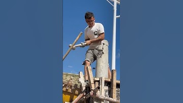 The process of a man vigorously dismantling a cement utility pole #automobile #xcavator #machine