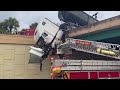 Truck driver rescued from cab dangling on Florida overpass