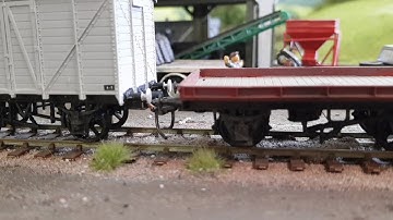 Automatic uncoupling using Kadee couplers and neodymium magnets buried in the track.