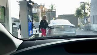 Blonde tesla driver at gas station. lol ...