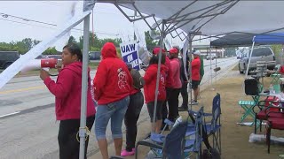 UAW members picket through the rain on day 11 of strike