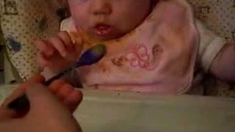 Baby Maddy feeds herself