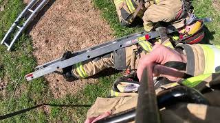Preparing a downed firefighter for basement removal via Fresno ladder