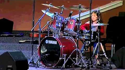 Madelyn Ryan playing drums at recital